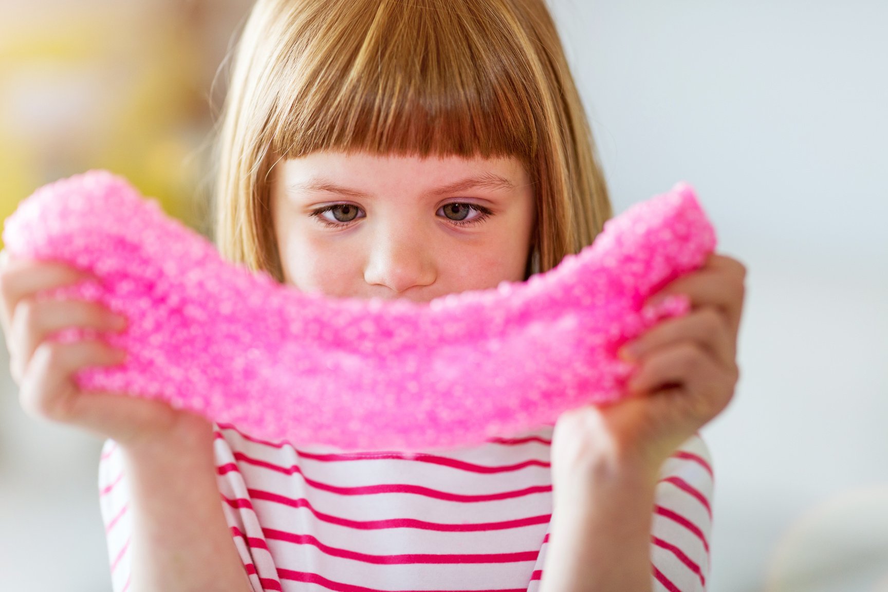 Little girl making homemade slime toy