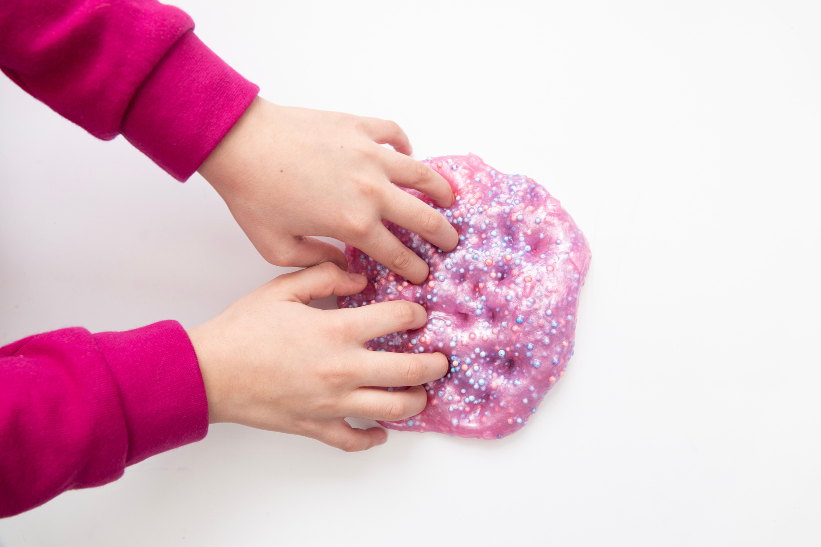 Kid Playing Handmade Toy Called Slime, Selective focus on Slime, Teenager having fun and being creative homemade slime